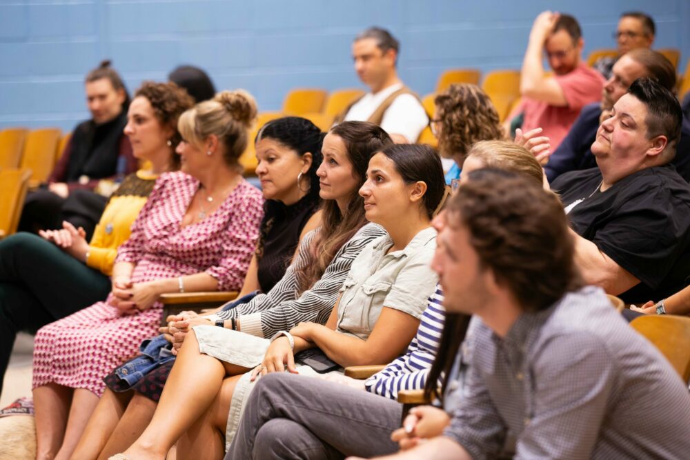 staff sit in the auditorium
