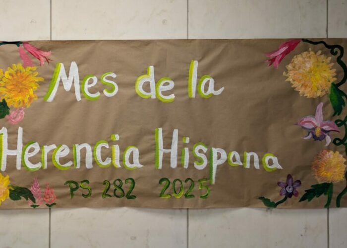 Banner from Hispanic Heritage Month that reads: "Mes de la Herencia Hispana" with a painted flowery border